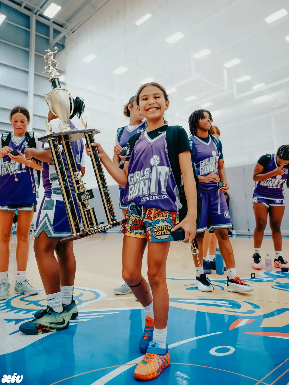 Girls Run It champion holding the trophy
